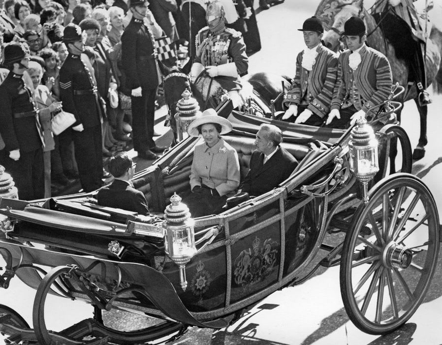 Queen Elizabeth II riding in a carriage to Buckingham Palace with Emperor Hirohito in 1971.