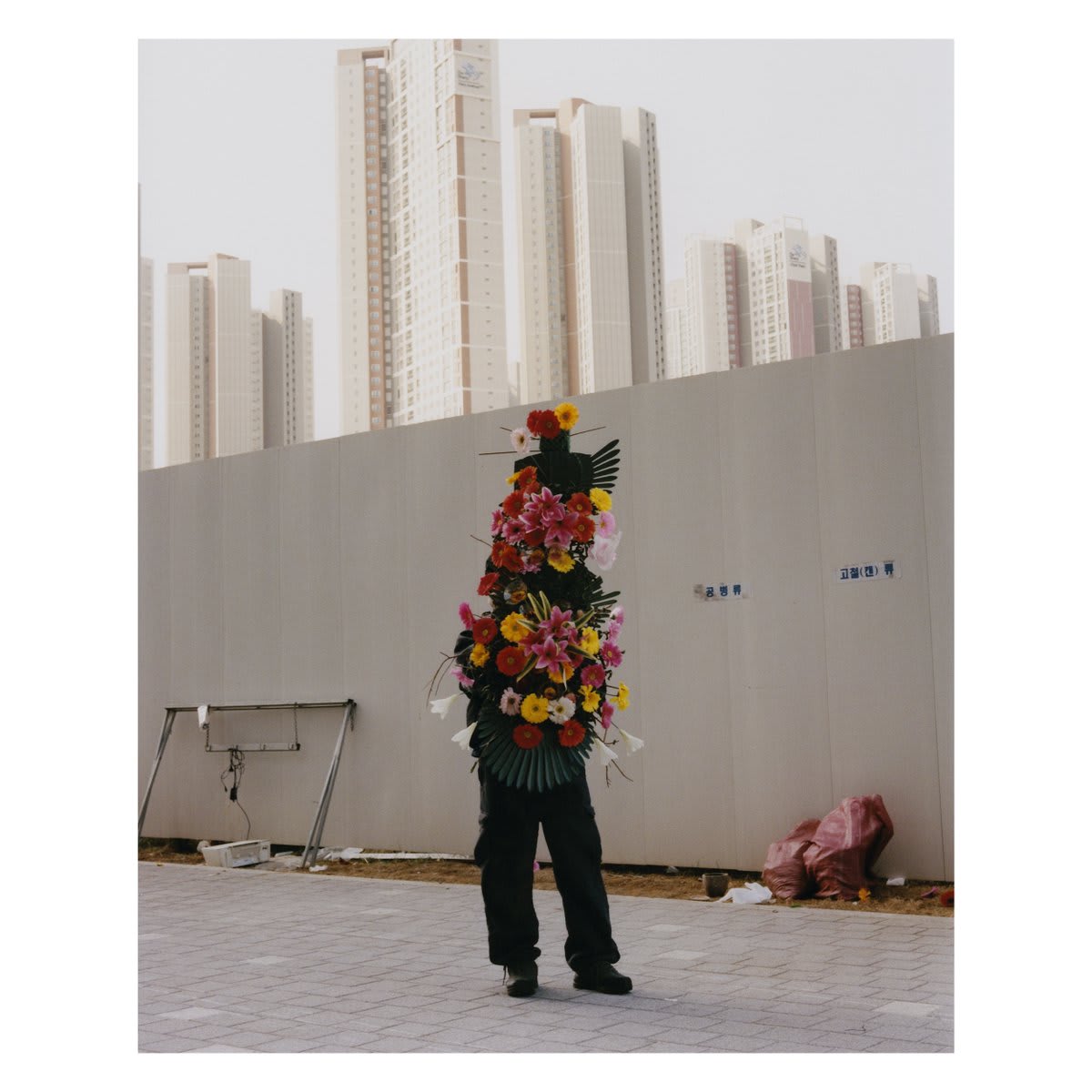Funeral Flower Man, South Korea. Feb 4, 2020. @aperturefnd's Olgaç Bozalp selects this image for Works of Imagination, the Magnum Square Print Sale in partnership with @aperturefnd. See all images available: https://t.co/T9HpH6dDMz © Olgaç Bozalp courtesy
