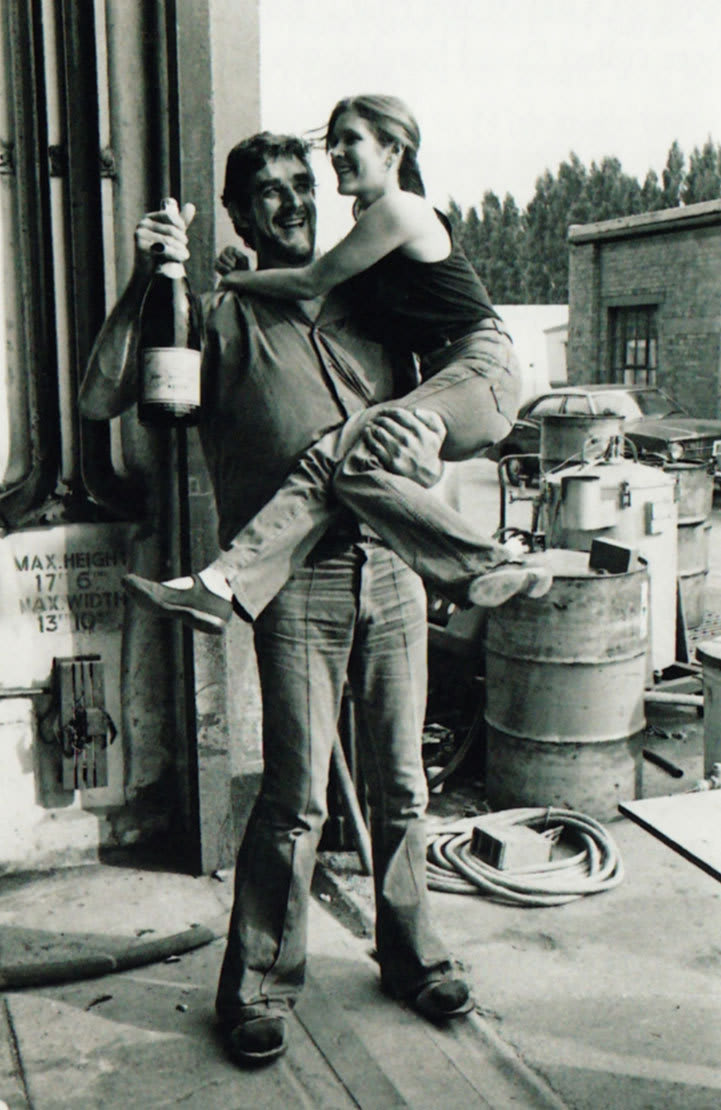 In honor of May The 4th, Peter Mayhew carrying Carrie Fisher with a giant bottle of Champagne.