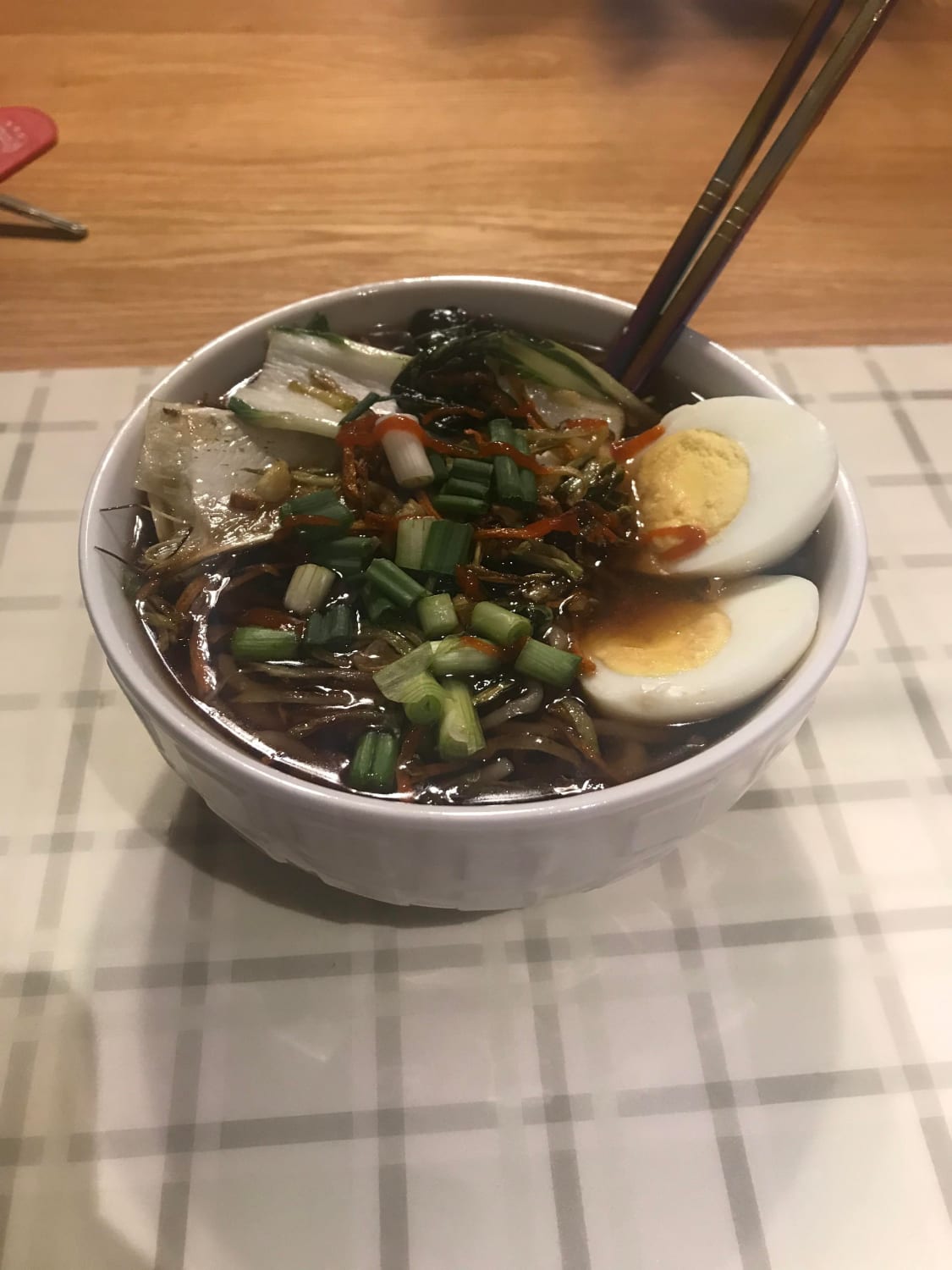 Shoyu ramen with first batch of noodles from scratch with bok choy, shredded carrots and cabbage, garlic, and ginger sautéed in sesame oil. Tare is from scratch as well
