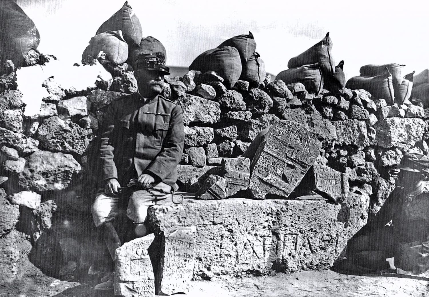 An Italian officer poses next to ancient ruins in a trench in Libya during the Italo-Turkish War, 1911