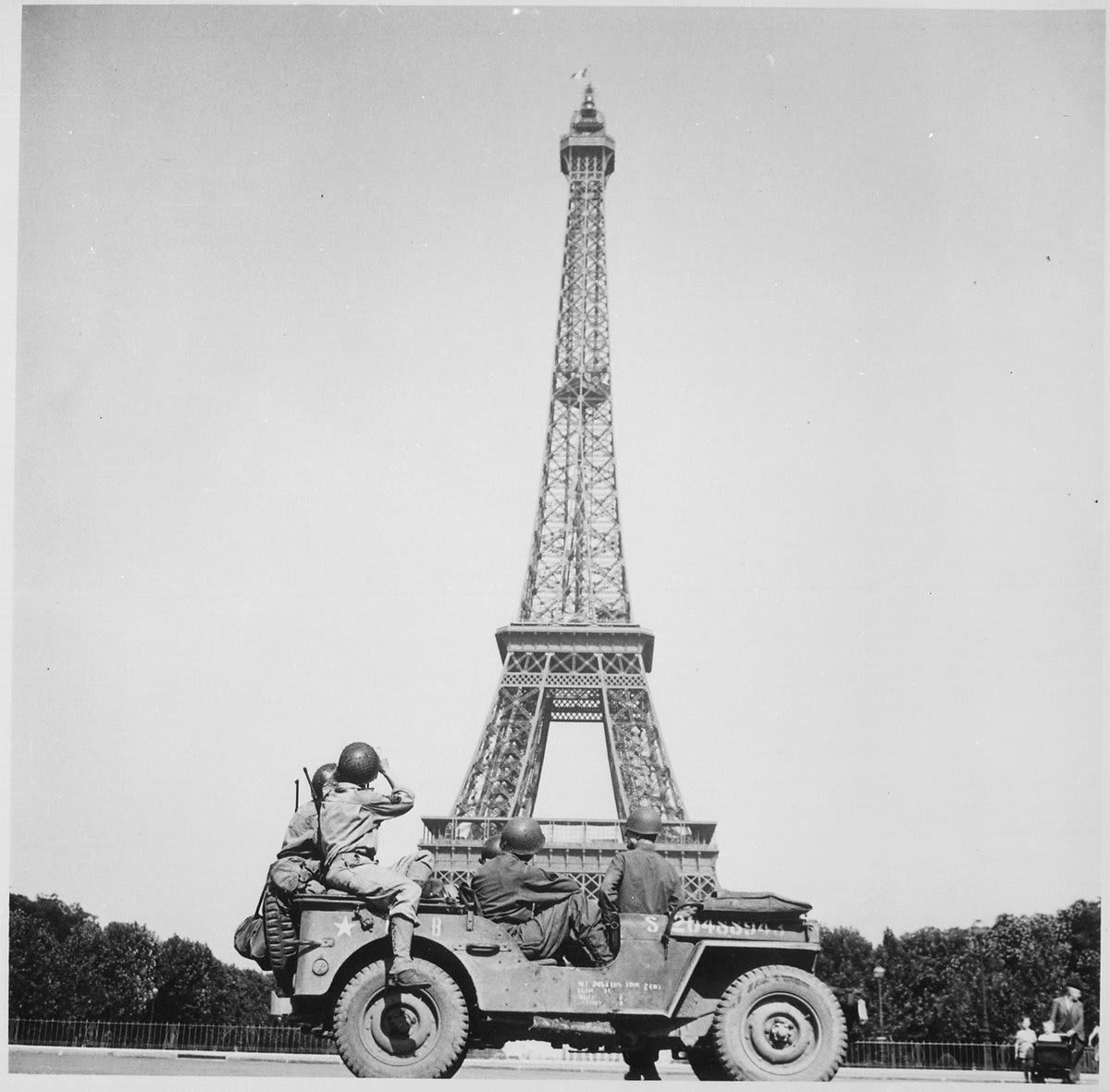 "Soldiers of the 4th U.S. Infantry Division look at the Eiffel Tower in Paris, after the French capital had been liberated on August 25, 1944." 75 years ago