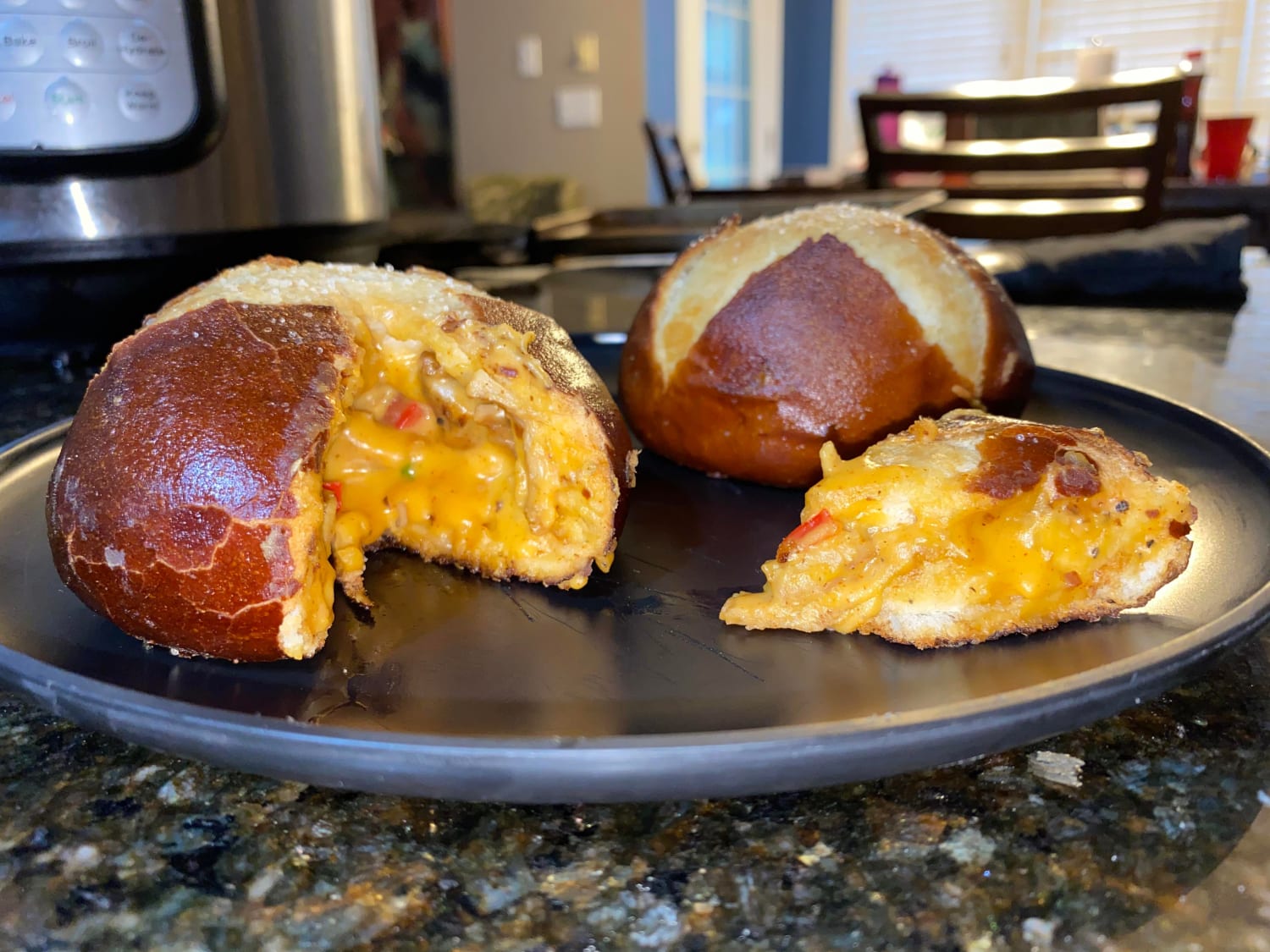 [homemade] Pretzel bun stuffed with spicy cheese, peppers, and seasoned chicken