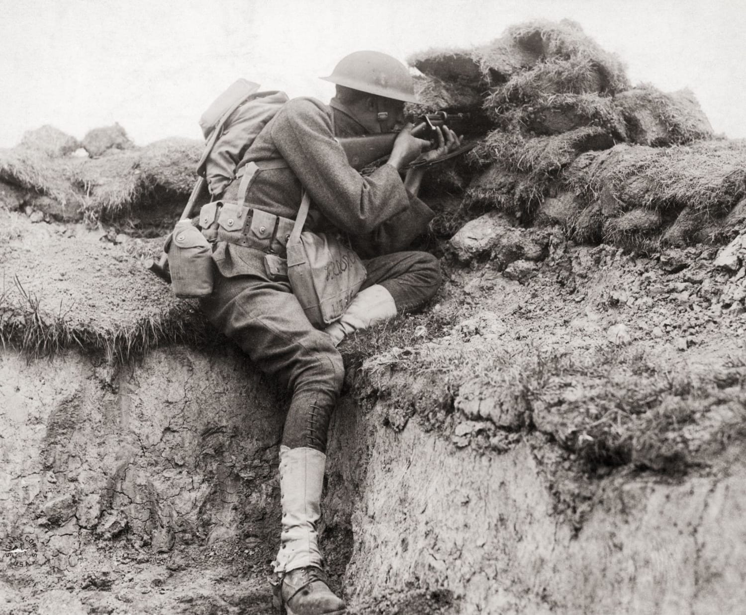 American sniper from the 30th Infantry Division searching for targets from a trench in Belgium. July 9, 1918.