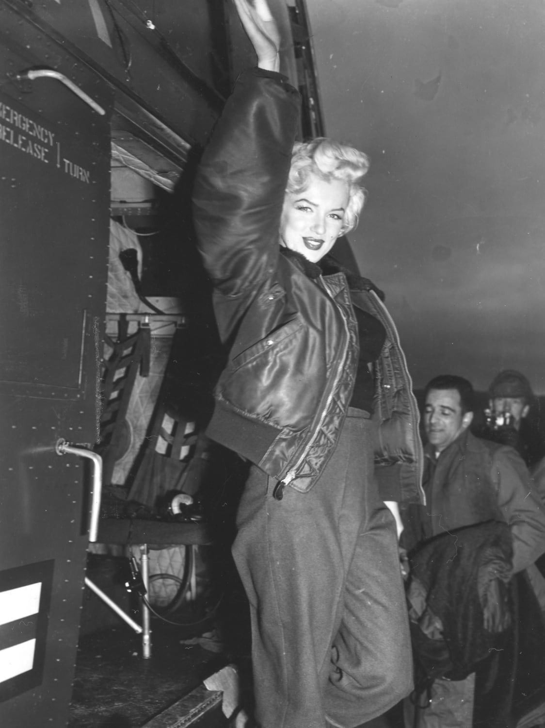 Marilyn Monroe posing by an H-19 helicopter during her USO tour in Korea, 1954.