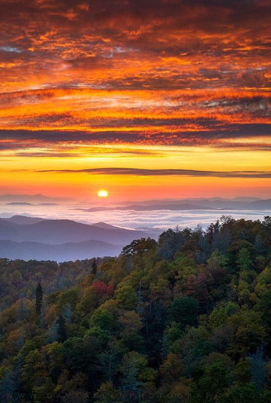 A brilliant sunrise on a cold autumn morning over the Southern Appalachian mountains, shot from the Blue Ridge Parkway south of Asheville, NC. Photo by Dave Allen Photography