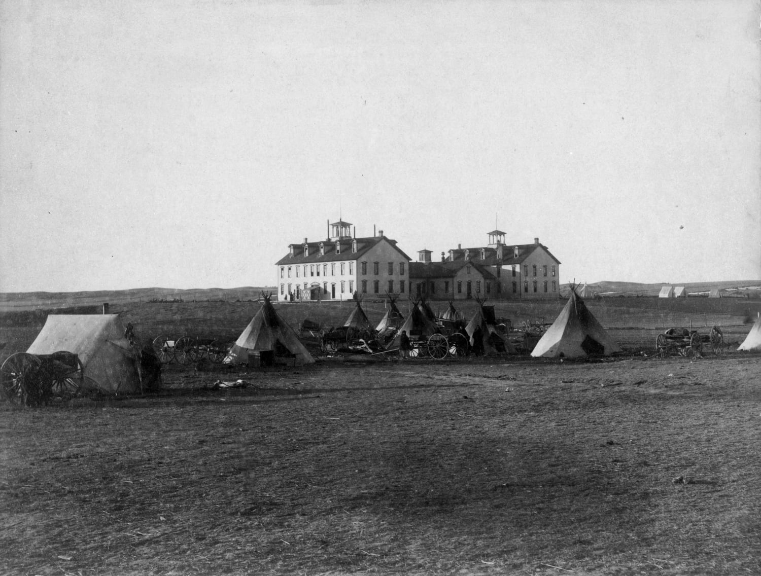 Native American parents camping outside Indian boarding schools where their children were (possibly) taken by force. Pine ridge, south Dakota, 1891.