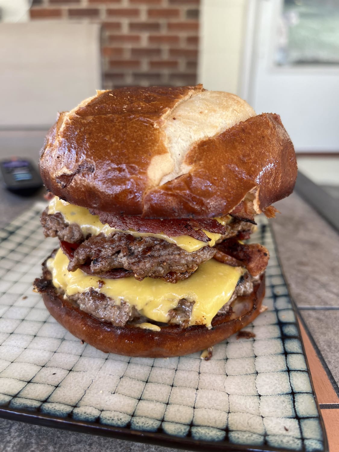 Double cheeseburger with bacon on a pretzel bun [homemade]