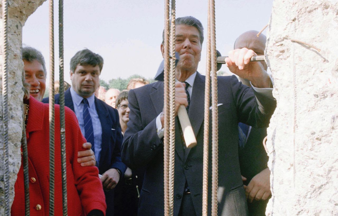 Ronald Reagan helping to tear down the Berlin Wall in 1990