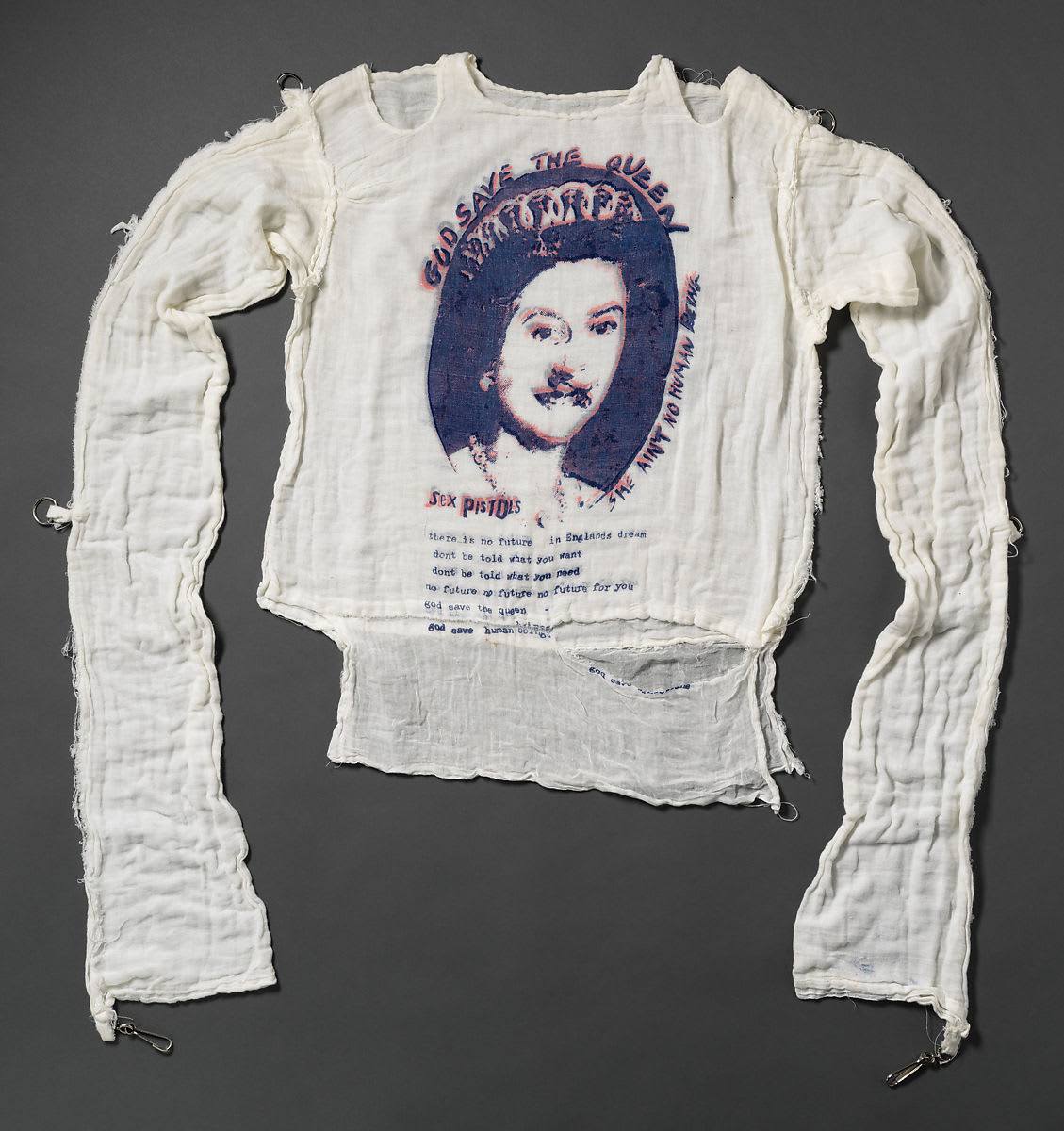 Vivienne Westwood and Malcom Mclaren’s 1977 “God Save the Queen” t-shirt features a bold graphic of Queen Elizabeth II by Jamie Reid, and became an iconic representation of early British Punk style and anti-fashion. Read more!