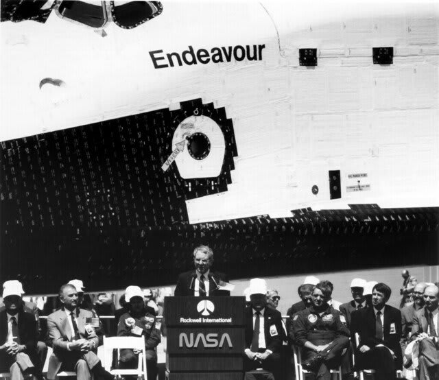 OTD 1991, Space Shuttle Orbiter Endeavour (built to replace Shuttle Challenger) rolls out of the assembly plant in Palmdale, California. In this picture, NASA Administrator Dick Truly speaks at the rollout ceremony.