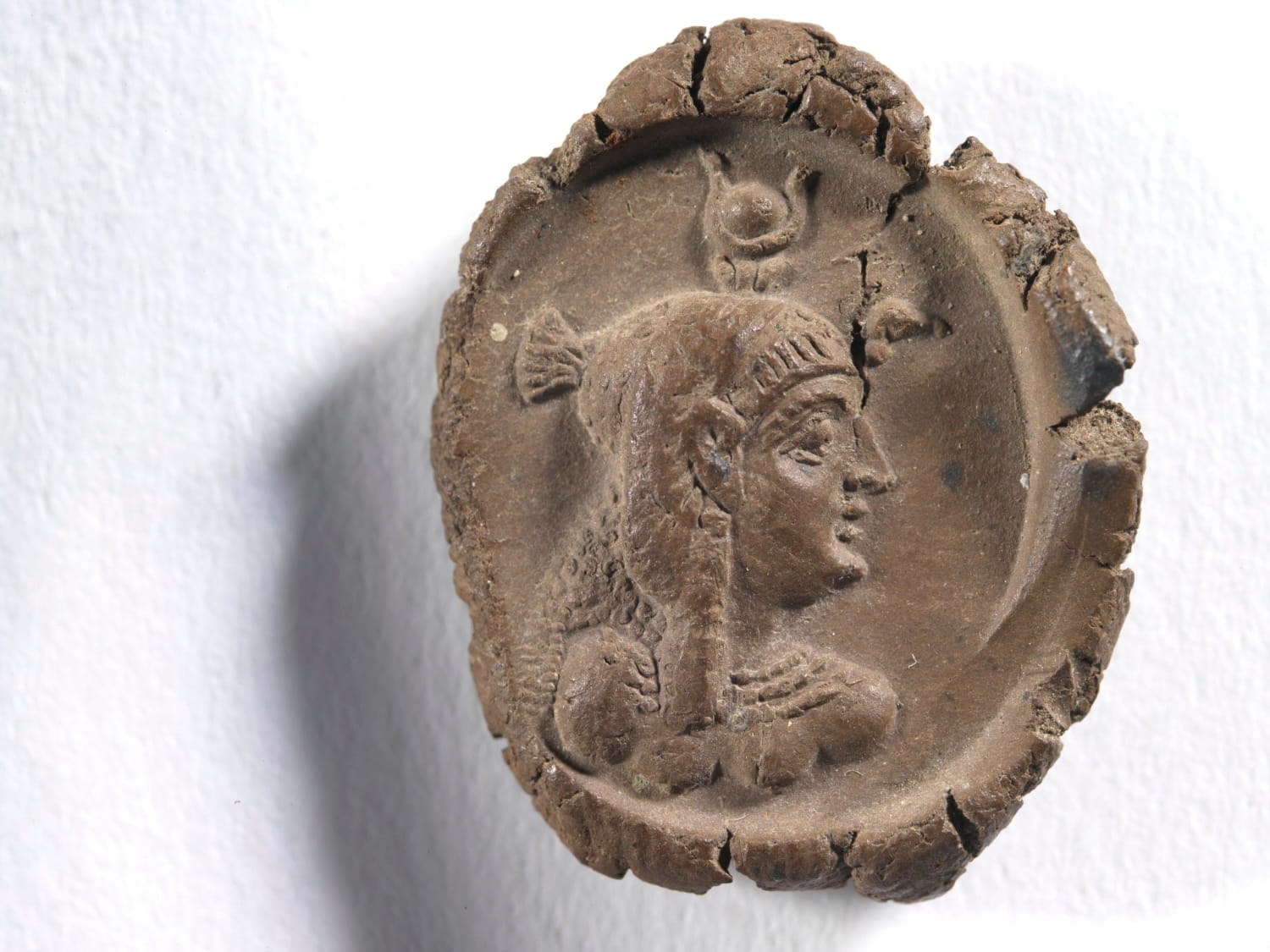 Seal impression with bust of Cleopatra VII wearing crown of Egypt, Dated to 50 - 30 BC. Material: Unfired Clay. Royal Ontario Museum.