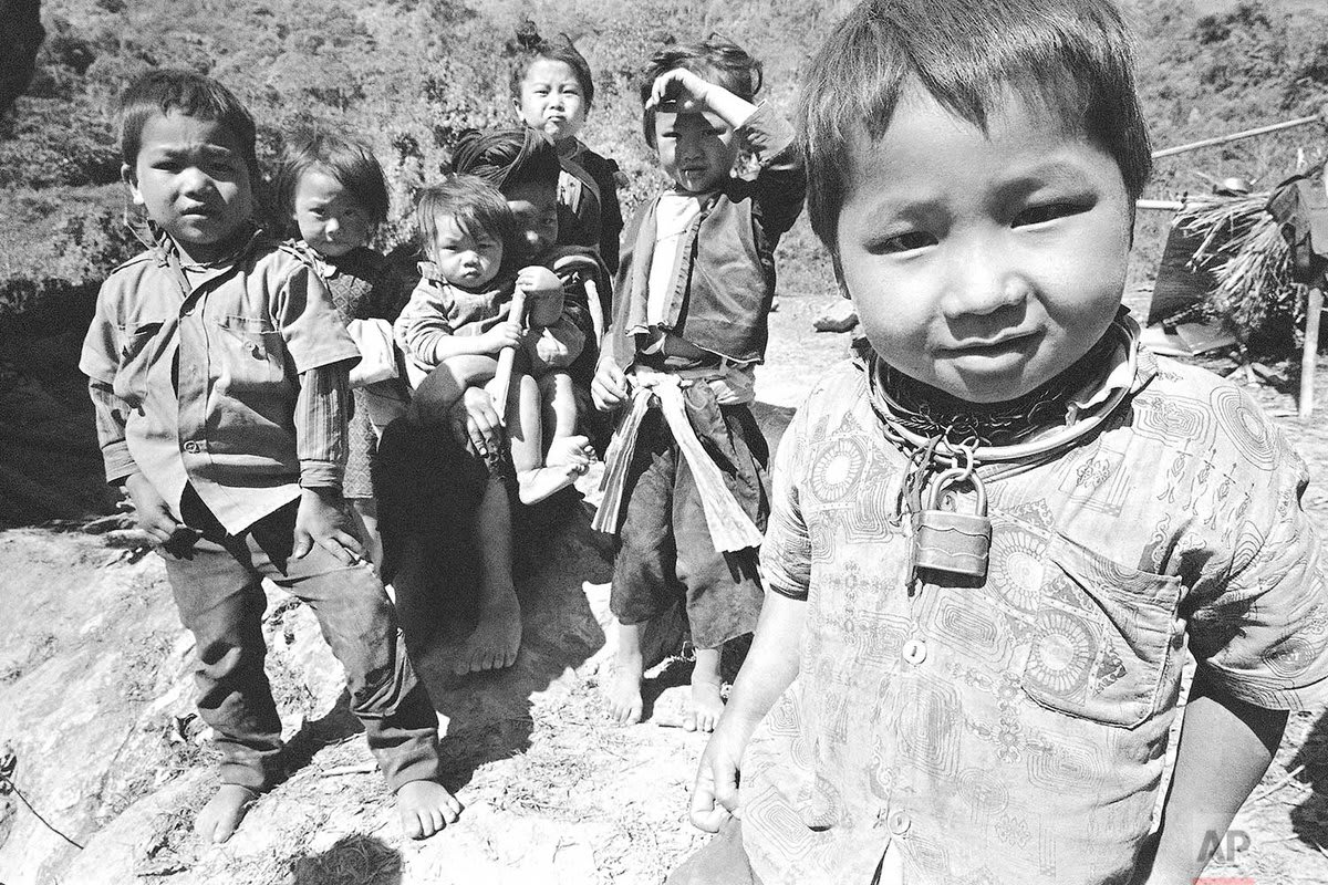 Hmong children travel on foot from a cave where their family stayed overnight during their flight from renewed fighting in the Long Cheng secret base area and the Plain of Jars in Laos in February 1971. | Photo Horst Faas