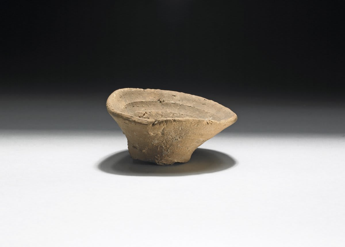 This 3,500-year-old object is a single-use cup made in ancient Crete. During this time, thousands of these small conical cups were made from clay – perhaps used for serving wine at feasts