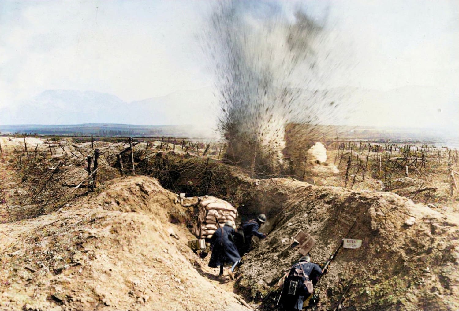 French soldiers in a trench take cover from an artillery shell. Fort de la Pompelle, Reims, France (ca 1915) [Colorized]