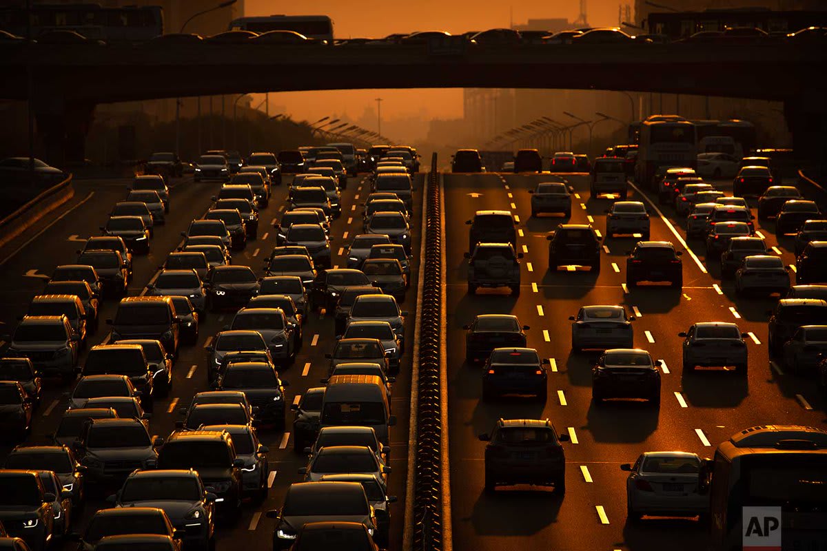 Commuters make their way along an expressway during rush hour today in Beijing. According to Chinese state media, the average concentration of PM2.5 fine air pollutants in Beijing in August was at the lowest level ever recorded for that month. | Photo Mark Schiefelbein