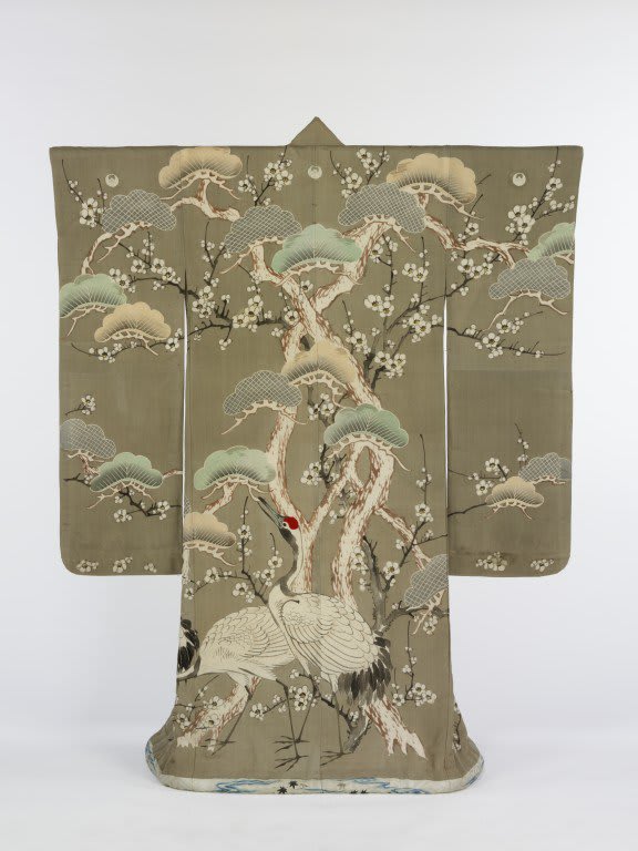 The design of this C.19th kimono showcases the close connection between painting and textile arts that exists in Japan. The surface of the garment has acted as a kind of hanging scroll for the creation of a hand-painted and dyed image of cranes among pines and plum blossoms.