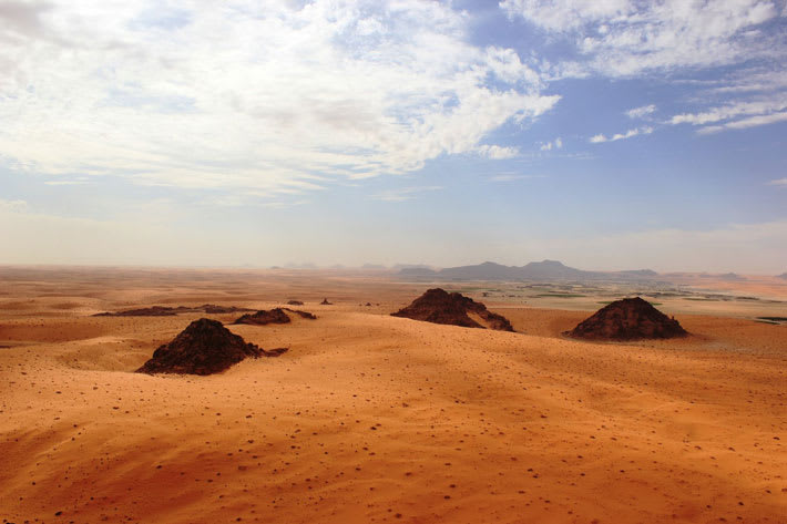 New research suggests that hominins repeatedly migrated through northern Arabia as early as some 400,000 years ago, as monsoon rains periodically transformed the desert landscape into habitable grassland.
