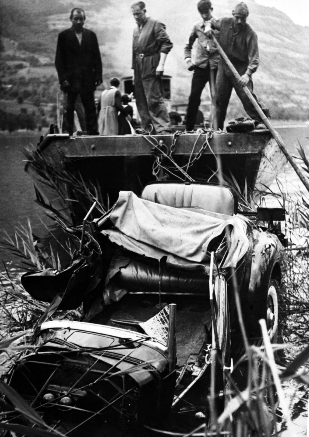 The wrecked car of Queen Astrid of Belgium being salvaged from the lake side near Lucerne, Switzerland on August 30, 1935, after the car crash in which she was killed while driving with her husband the day before. AP