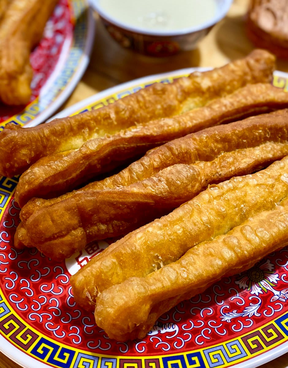 However, in all the youtiao-eating lands, form and flavor are fairly consistent — it is a long, airy, slightly savory doughnut, made of two pieces of dough stuck together and deep-fried. Here's how to make @jingtastic's perfectly airy, crisp youtiao: