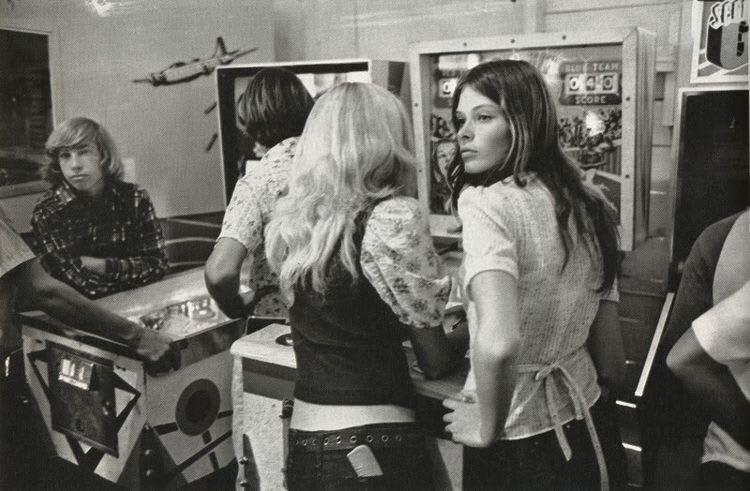 Teens hanging out at the arcade, 1976