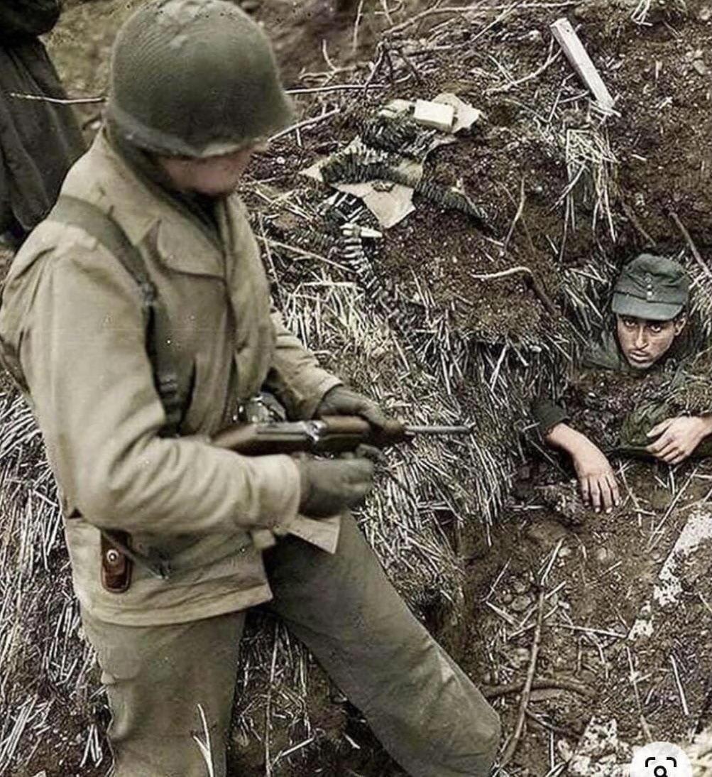 1st Lieutenant Roy “Buck” Rodgers of the 102nd Infantry Division discovers a German who buried himself in an attempt to avoid capture near the town of Linnich, North-Rhine Westphalia, February, 1945. (Original color photo)