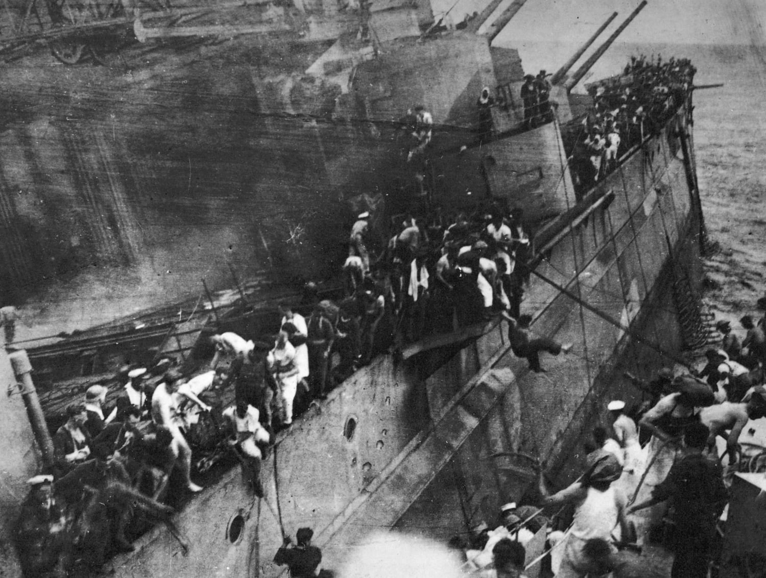 "Britain's Pearl Harbour"; sailors jump from the sinking battleship HMS Prince of Wales to the waiting destroyer HMS Electra. By the end of the day, 840 men would be dead and a battleship and battlecruiser sunk; for the cost of 4 Japanese dive bombers. 10th December 1941