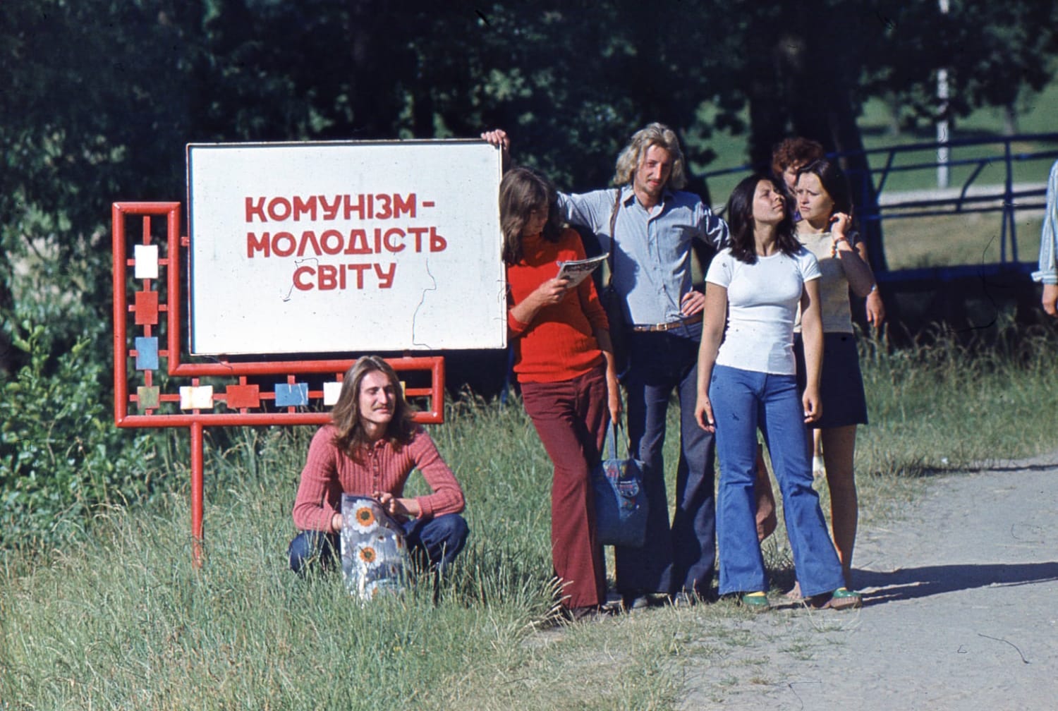 A group of hippies. Lviv, Ukraine, 1988. The sign reads: "Communism is the youthfulness of the world"
