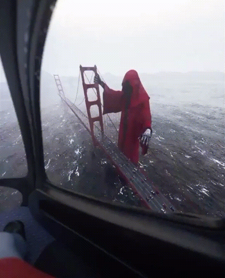 This CGI render of a giant red death holding onto the Golden Gate Bridge