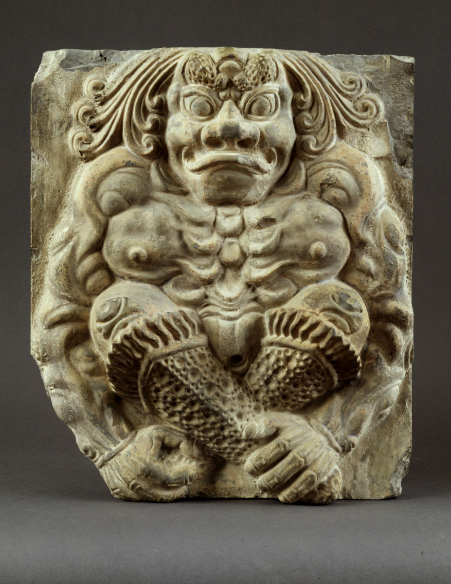 Wall tile depicting a sitting demon. China, Tang Dynasty, 7th century
