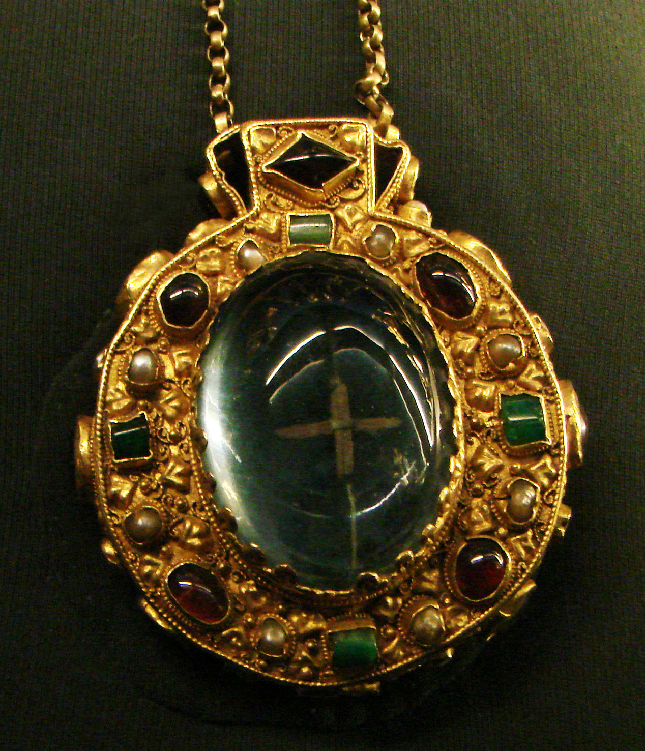 This golden talisman was buried with Charlemagne, King of the Franks, at Aix-la-Chapelle in 814. It has two large cabochon sapphires, set over wood remnants of the Holy Cross. It was removed to the Cathedral in 1000 and later worn by the Empress Josephine in 1804.