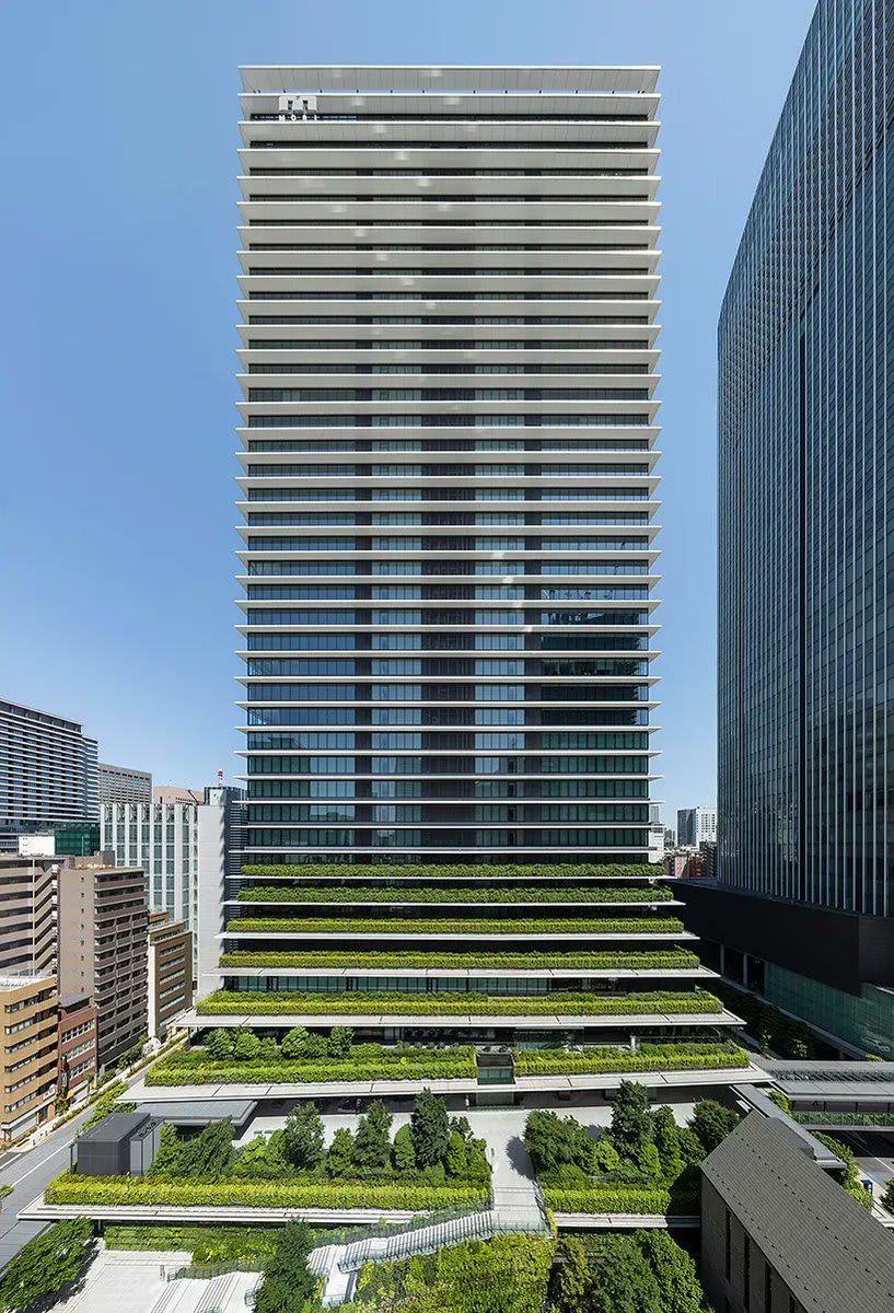 in tokyo, ingenhoven architects completes two towers connected by an elevated park, all covered with lush gardens.