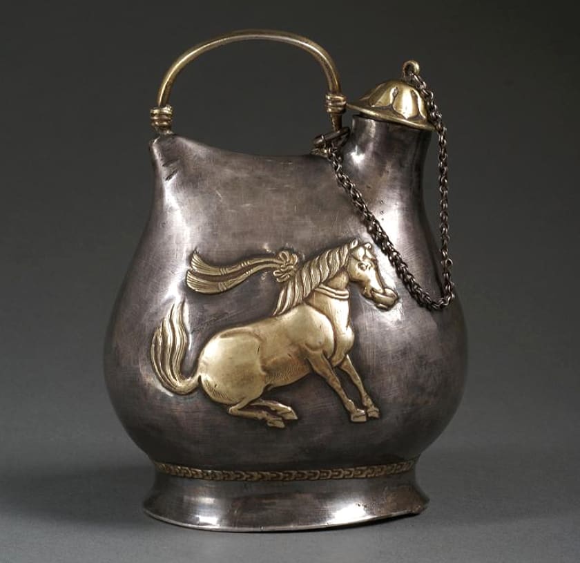 Silver flask with a dancing horse holding a cup in its mouth. China, Tang Dynasty, 618-907 AD