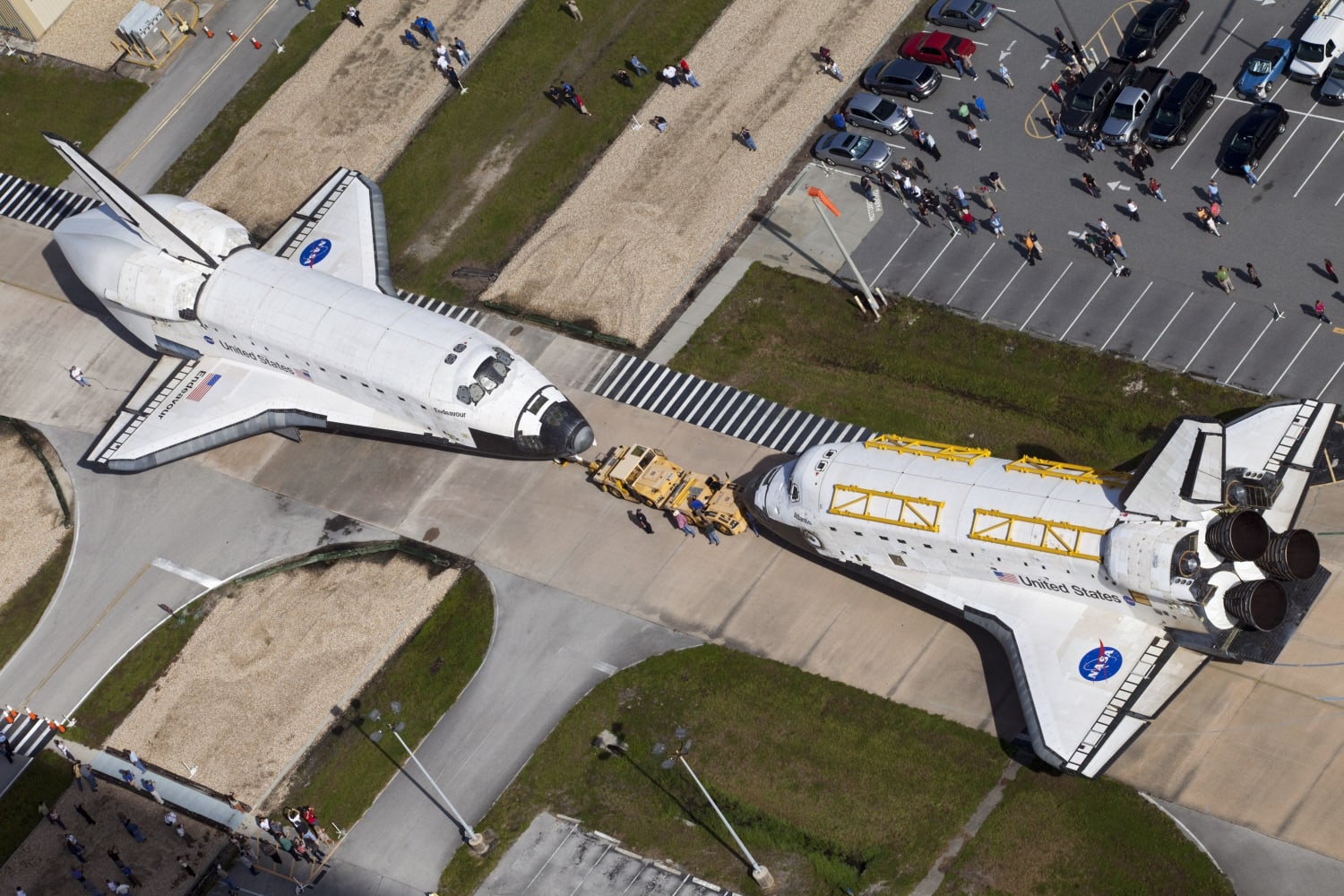 NASA's Space Shuttle Endeavour (left) and NASA's Space Shuttle Atlantis (right) "are parked nose-to-nose for a brief photo opportunity" on 16 August 2012. "The shuttles are switching locations" at John F. Kennedy Space Center in Florida, United States of America. Photographer: Frankie Martin, NASA