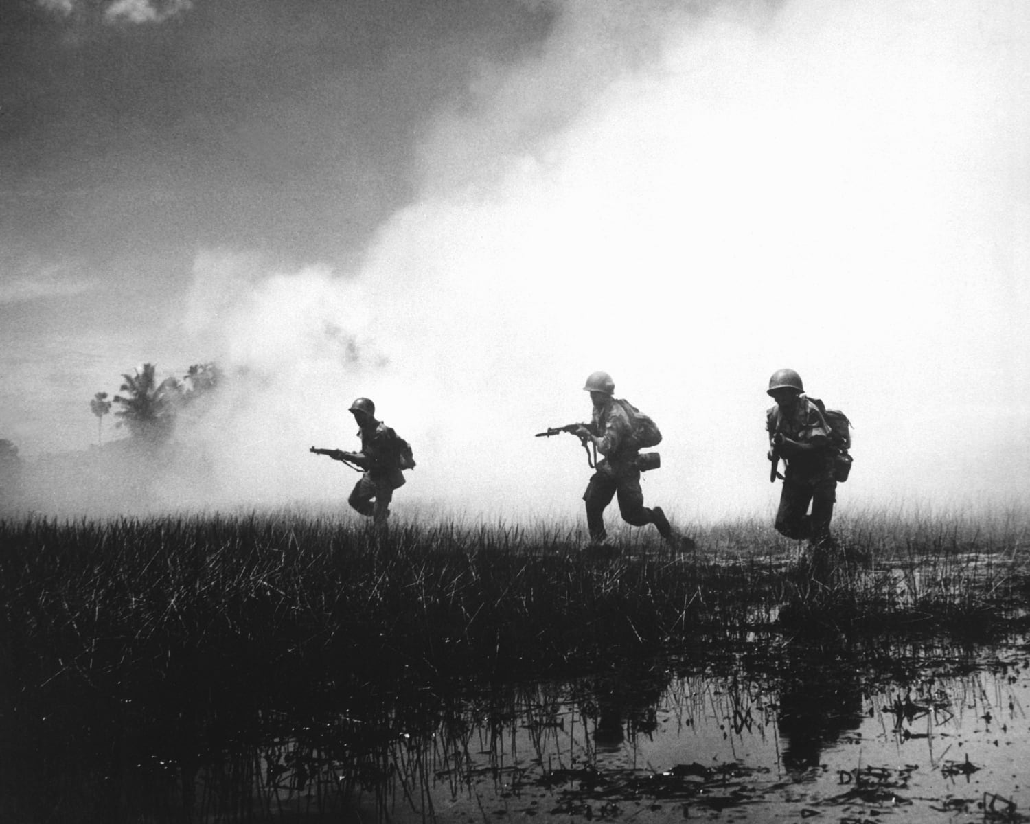 South-Vietnamese forces assault an enemy stronghold in the Mekong Delta, 1961.