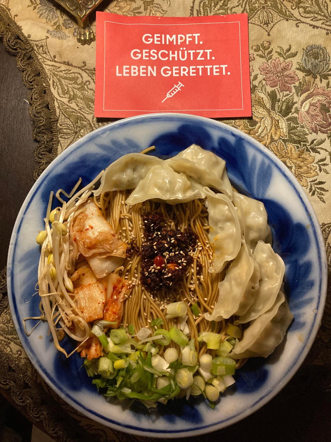 Greetings from Germany! At home feeling sick after my booster shot, so I quickly whipped up some ramen (broth: ginger+mushroom dark soy sauce+Soon veggie ramen seasoning packet) with various add-ons: (veggie dumplings, spring onions, kimchi, bean sprouts, sesame seeds, and Lao Gan Ma chili crisp)