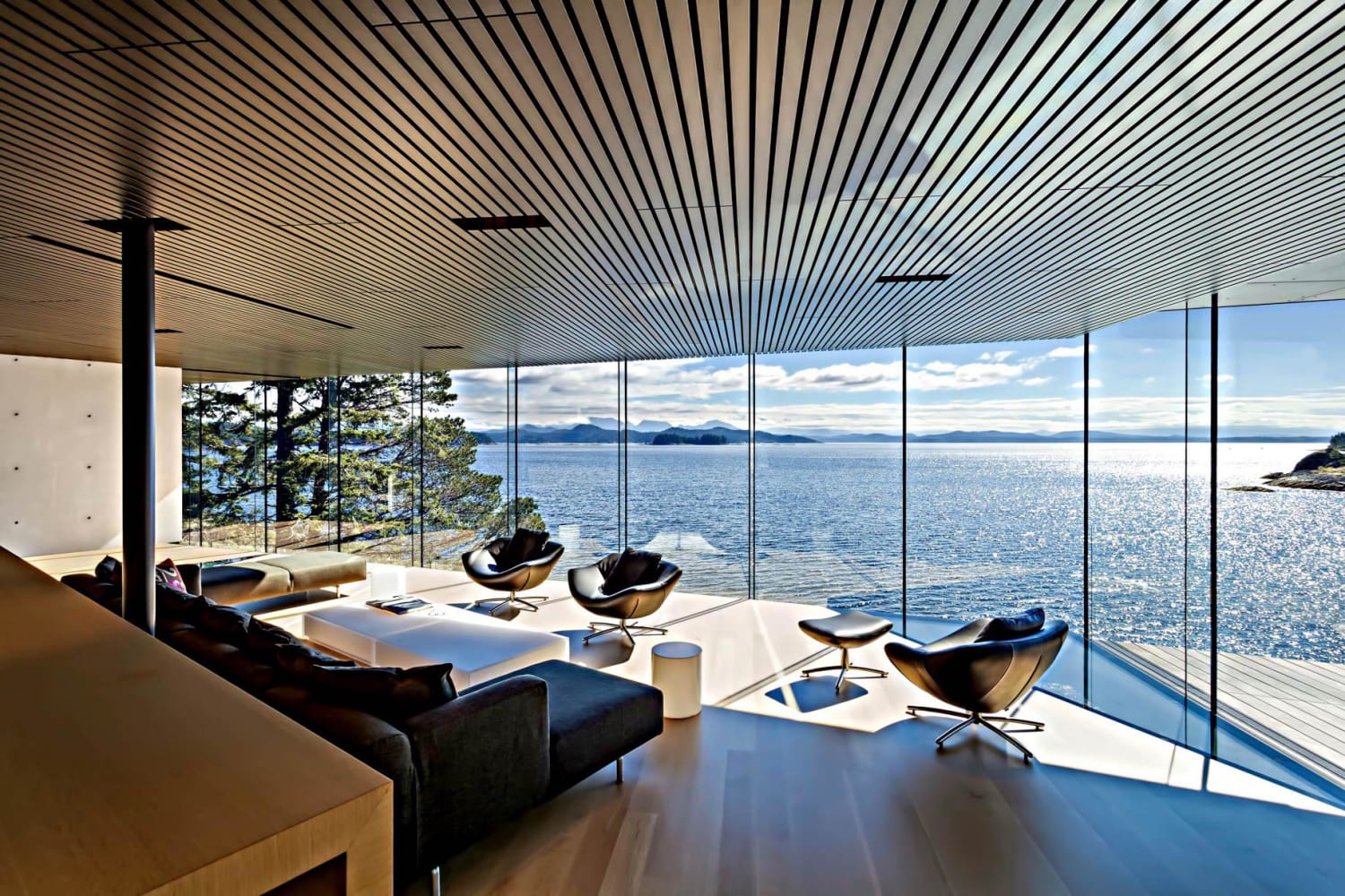 Modern living room with glass wall views - Quadra Island, BC, Canada