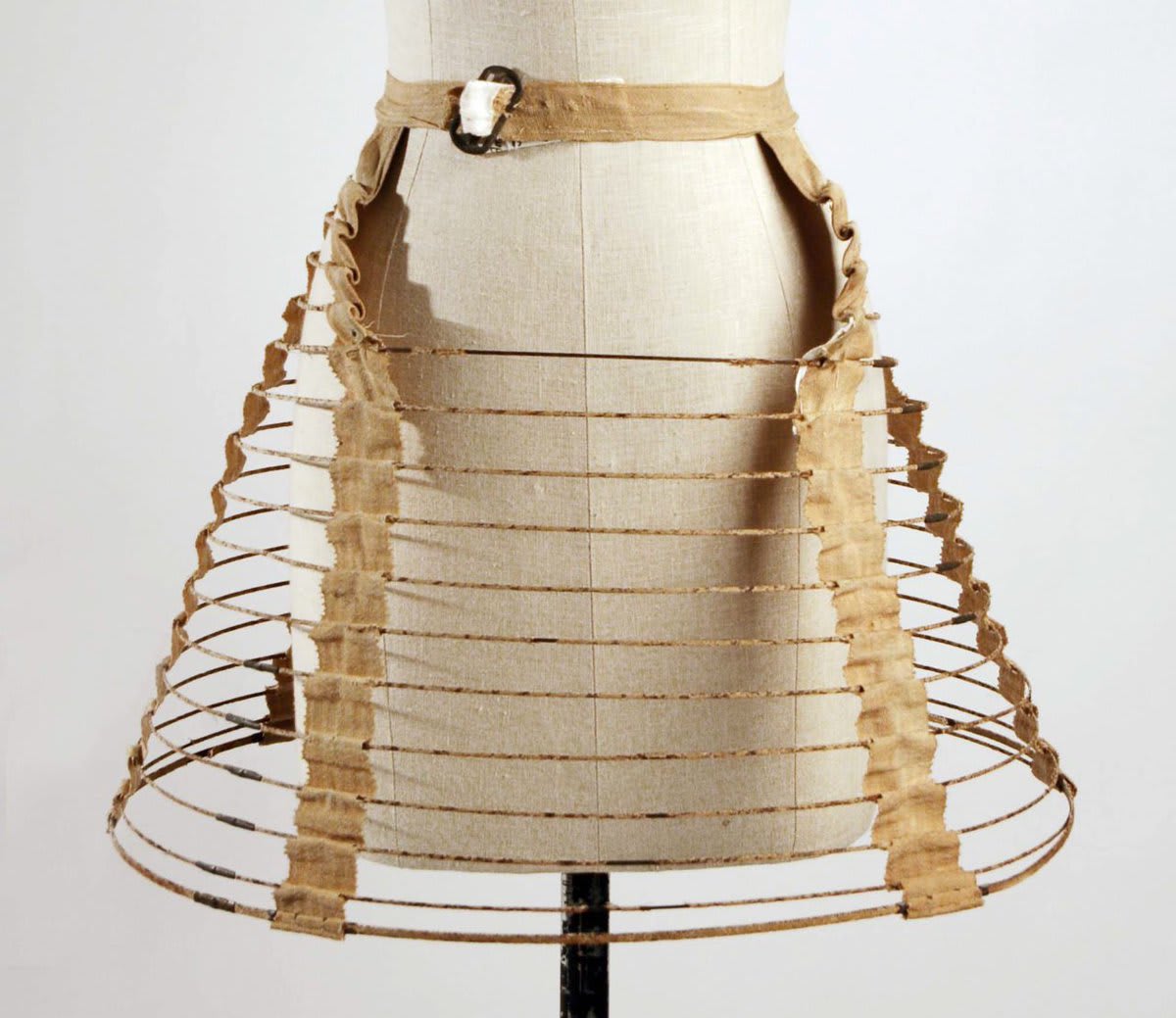 The cage crinoline is a hooped cage worn under petticoats in the 1850s/1860s to stiffen and extend the skirt. It was one of the first mass-produced fashions and was widely adopted by all societal classes. Read more at the link below!