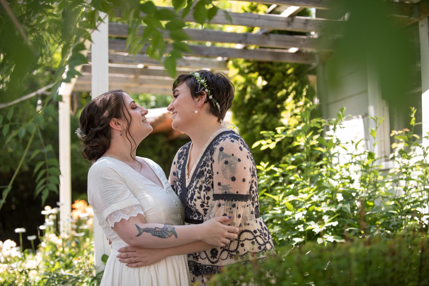 Have a gay wedding photo. As a treat. (Me: r with embroidered dress, NB lesbian; my wife: in white dress, bi)