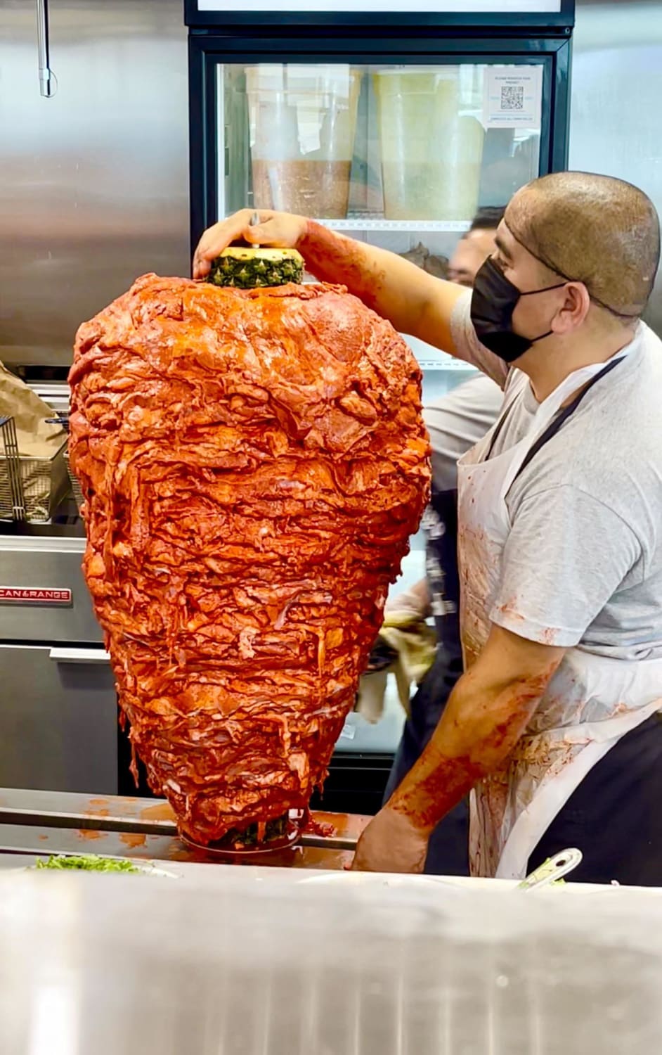 Al pastor meat about to be loaded on a vertical spit, he’s waiting for the forklift