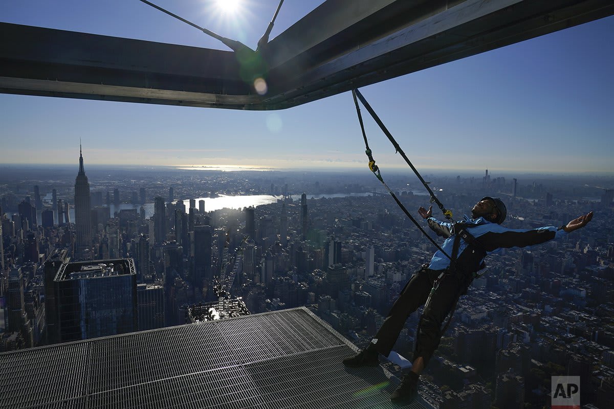 Climb guide Jason Johnson leans off the edge at the top of City Climb, a new attraction at 30 Hudson Yards in New York, Nov. 3, 2021.