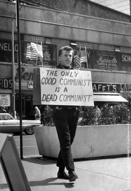 Nightclub owner Jack L. Hickman marched around Times Square with a sign reading “The only good communist is a dead communist”. New York City, April, 1965.