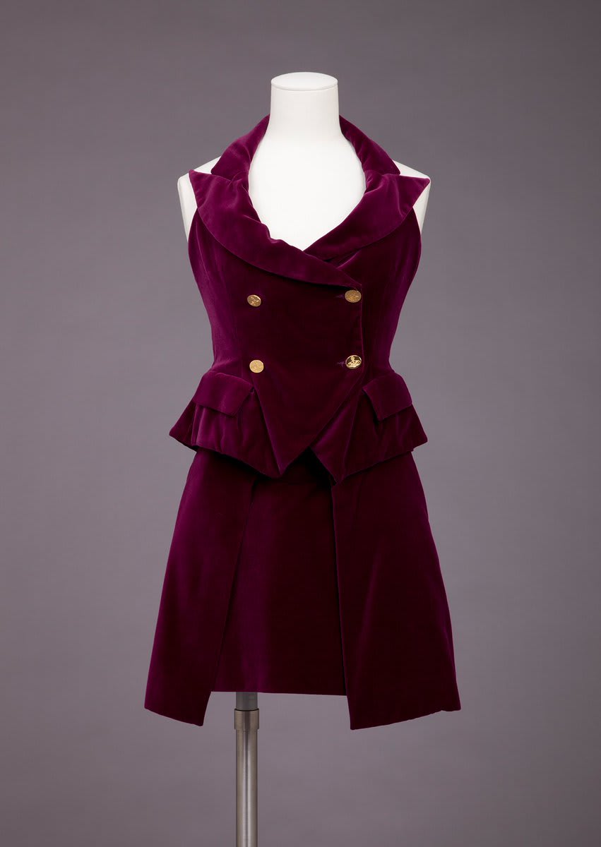 Happy birthday to Dame Vivienne Westwood! Punk, new wave, and fabulously counter-culture, Westwood brought the edge to her designs, like this two piece dress from 1995-2000. The deep plum velveteen contrasts perfectly with gold buttons, and hides a secret bustier within the top.