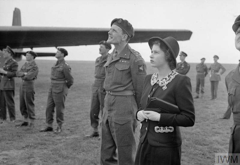 During the Second World War, Princess Elizabeth was the first female royal to serve full-time in Britain’s military. In this image, we see her watching parachutists dropping during a visit to airborne forces in England in the run-up to #DDay. © IWM (H 38619)