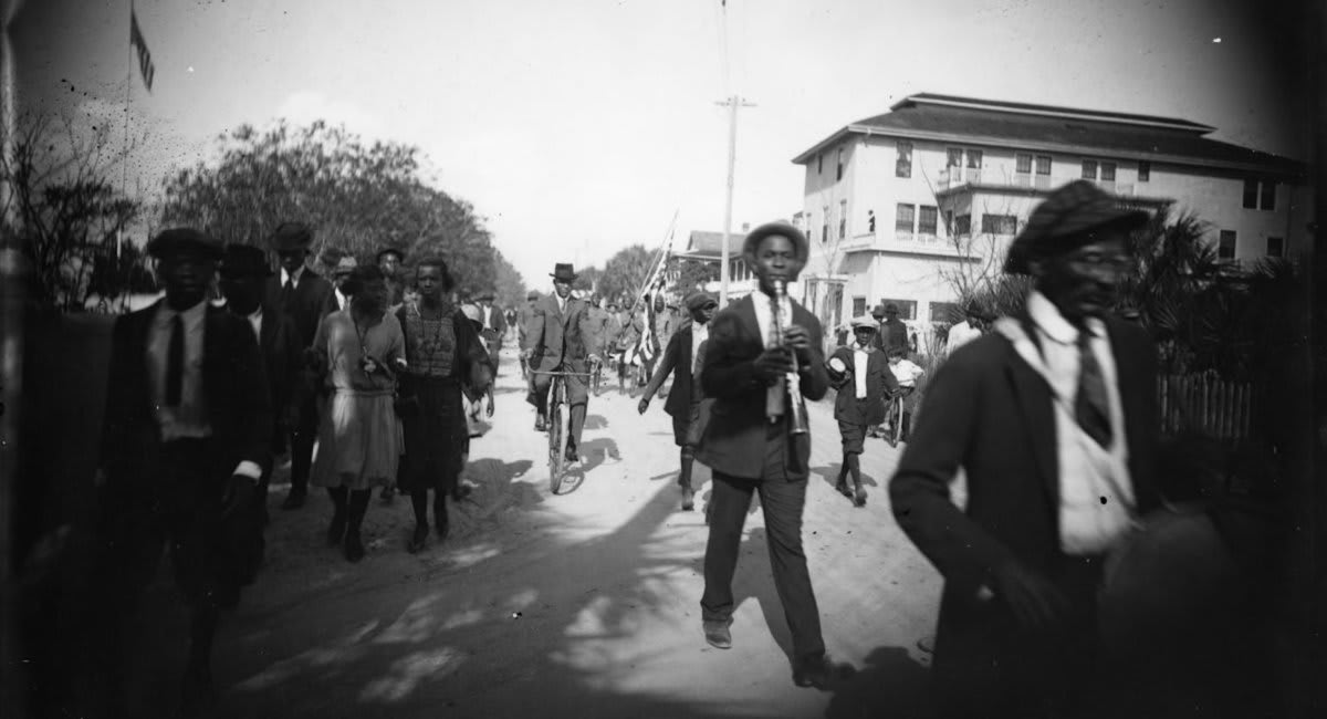 Black Americans celebrate Juneteenth, which commemorates their fathers’ and grandfathers’ emancipation from slavery 59 years ago. Here in Saint Augustine, Florida, a band parades down Main Street: