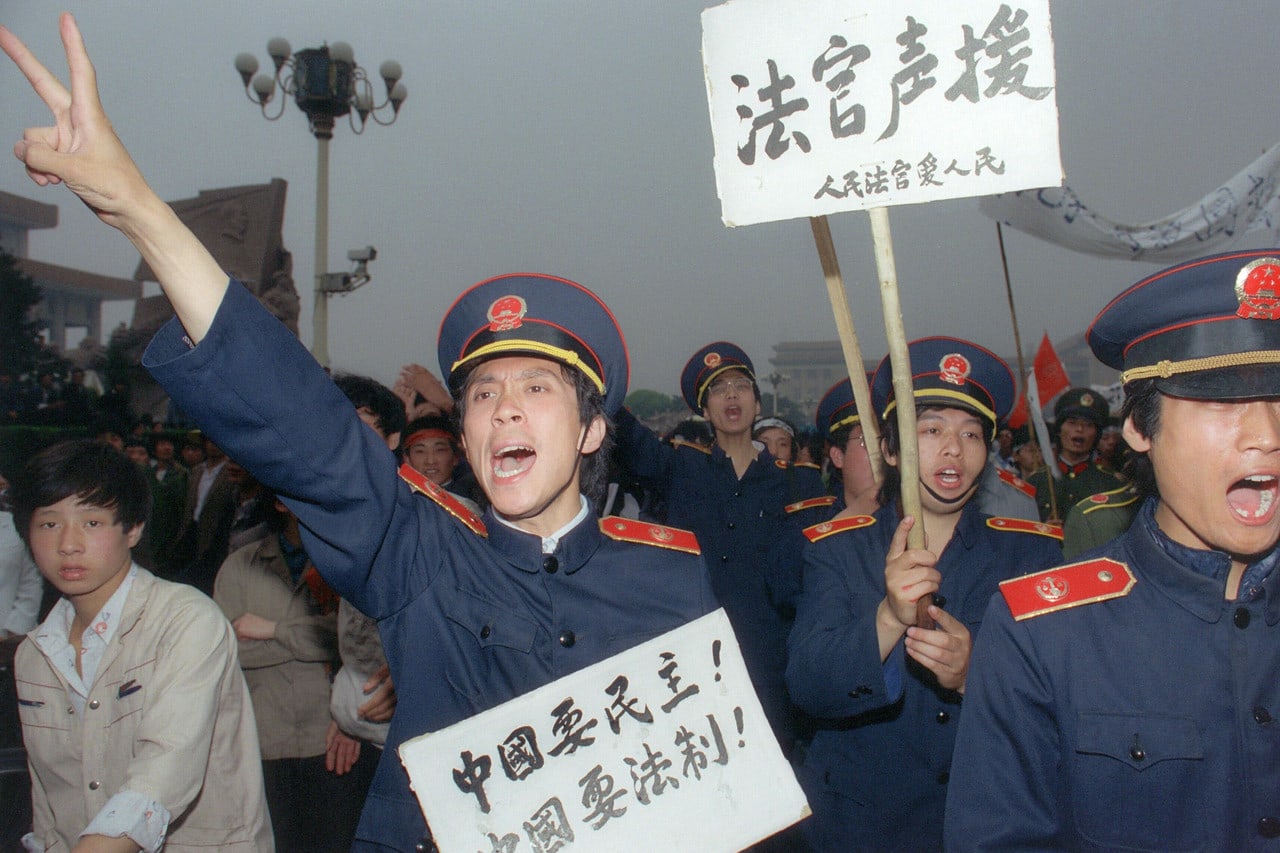 Tiananmen Square protests, Beijing magistrates wearing court uniforms join workers demonstrating in the streets in support of student hunger strikers / May 18, 1989 /