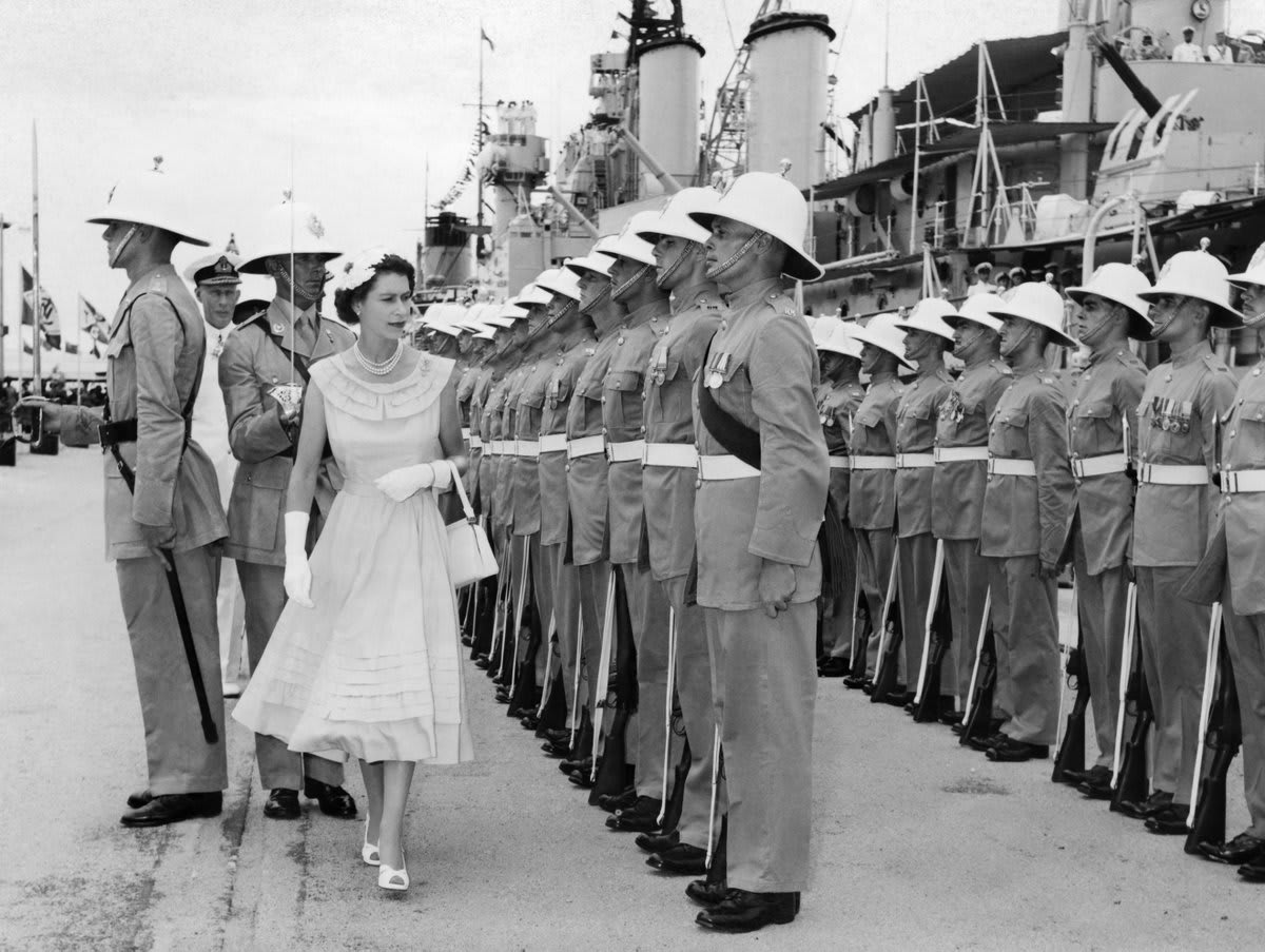 In this photograph from April 1954, The Queen inspects the Royal Guard of Royal Marines from the light cruiser, HMS Newfoundland during her visit to Colombo, Ceylon (now Sri Lanka). PlatinumParty © IWM A 32913