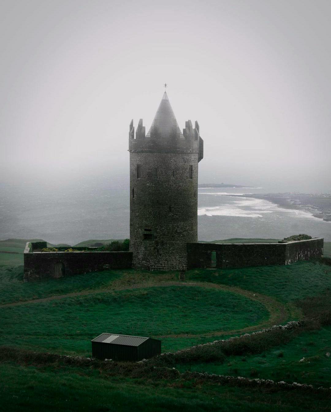 The 16th century Doonagore Castle overlooking the Atlantic Ocean in Doolin, Clare, Ireland.