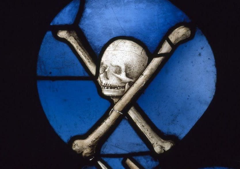 'Triumph of Death over the Laity' - A coloured glass panel depicting the skull and crossbones triumphant over the falling symbols of the laity (inc. crown, helmet, weapons, cap, tools). Originally from Saint Herbland in Rouen, Normandy. c.1520-1530 (@V_and_A)