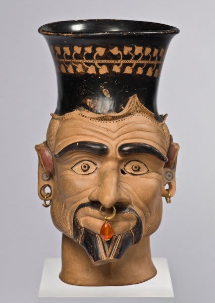 An Etruscan cup with head of Charun, one of the psychopompoi of the underworld. 400-300 BCE, now on display at the Staatliche Antikensammlungen in Munich
